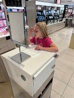 May - putting on makeup Putting on makeup while shopping with Mom